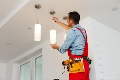 An electrician working on a project from a home services marketing agency
