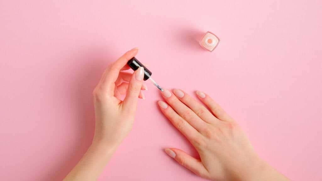 woman applying nail polish after seeing a marketing ad