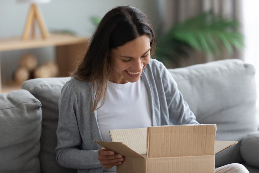 A woman opening a subscription box