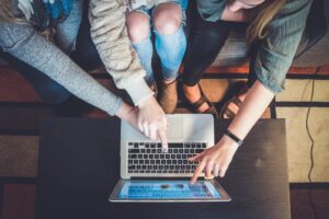 lead generation tools image showing friends looking and pointing at something on a laptop's screen