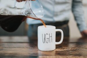 lead generation landing page mistakes showing an executive pouring coffee in a cup that says "UGH"