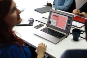 website design services image showing a woman in front of a laptop with the word "IDEAS" on the screen