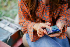 woman engages with a Facebook ad on her phone.