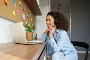 A woman at a laptop working to build niche relevant backlinks for her website