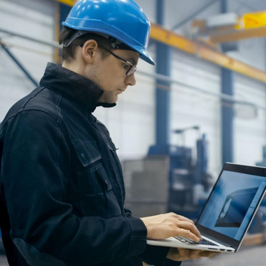 A man looking at an SEO strategy for his manufacturing company on his laptop